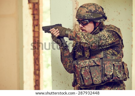 military. soldier with pistol in nato germany uniform with pistol indoord
