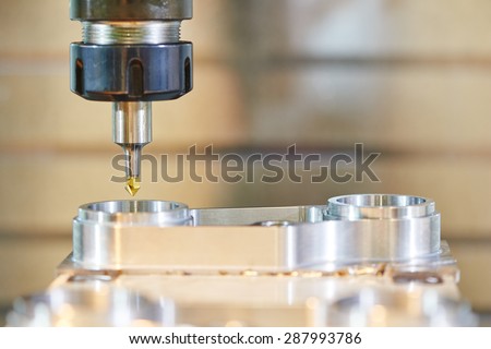 Milling machine tool with mill in chuck preparing to process metal detail at industrial manufacture factory