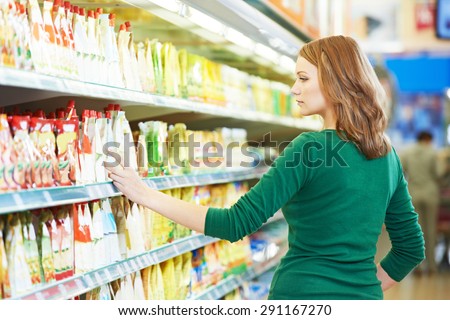 Shopping. Woman choosing bio food cheese products in dairy store or supermarket