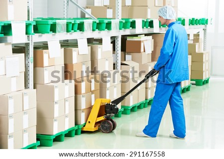 medical warehouse worker man loading boxes with medcine drugs by hand forklift