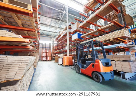 warehouse forklift stacker loader stacking cardboxes in storehouse