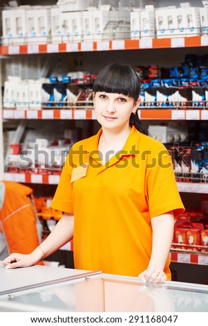 Positive female seller or shop assistant portrait  in hardware supermarket store