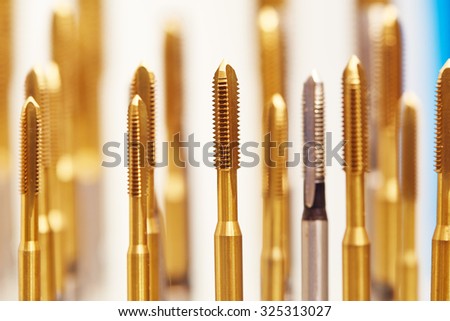 heap of finished metal thread tap tools with protective coating, Shallow DOF