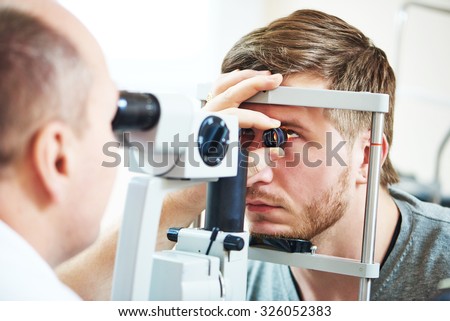Ophthalmology concept. Male patient under eye vision examination in eyesight ophthalmological correction clinic