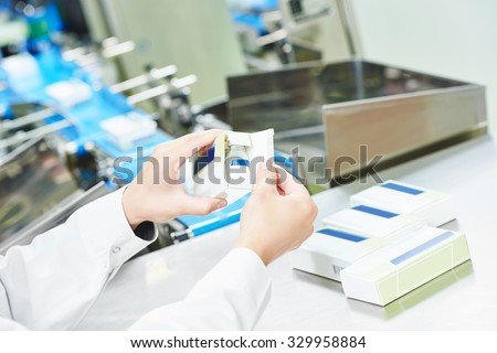 pharmaceutical factory worker at pharmacy industry manufacture packing medicine into boxes