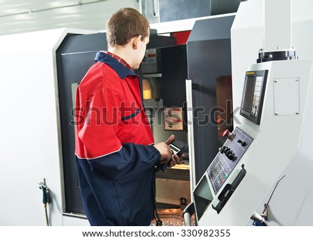 mechanical technician service engineer worker at cnc metal machining milling center in tool workshop