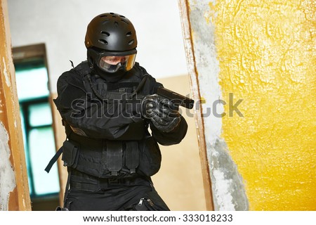 Military industry. Special forces or anti-terrorist police soldier, private military contractor armed with pistol ready to attack during clean-up operation, mission