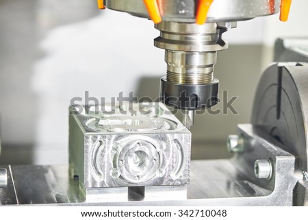Milling machine tool with mill in chuck preparing to process metal detail at industrial manufacture factory