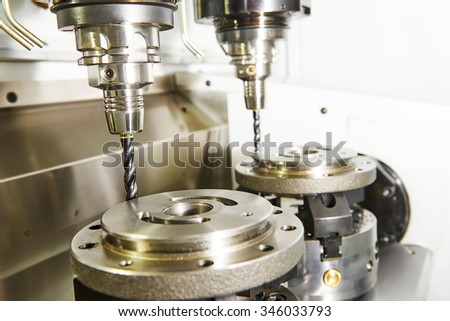 Metalwork industry. Milling machine tool with two mills in chuck preparing to process metal detail at industrial manufacture factory