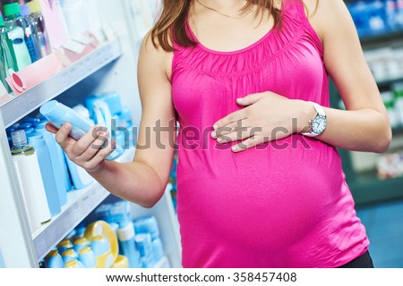 pregnant woman shopping at cosmetic shop