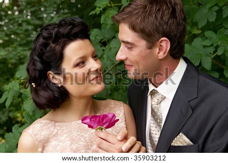 Close-up portrait of young couple outdoors. Woman tenderly lookingat the man. Find other nice peoples photos in my portfolio.