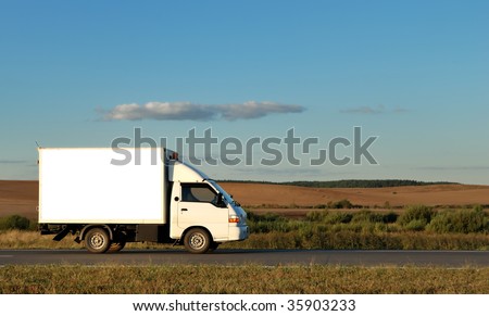 White Light-duty truck on highway over blue sky. See my portfolio for trucks and lorries
