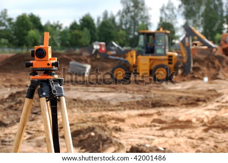 Using theodolite at construction site for land level measurement