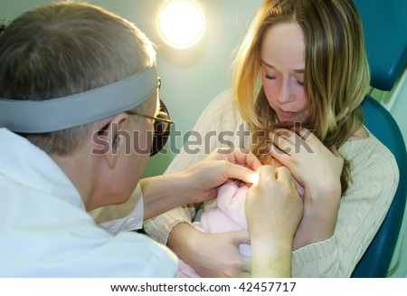 Medical examination of a little child at a ear nose throat doctor