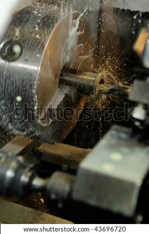 Operation of counter boring a hole in metal blank on turning machine by cutter with coolant
