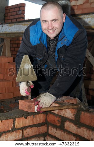 mason worker bricklayer making a brickwork with trowel