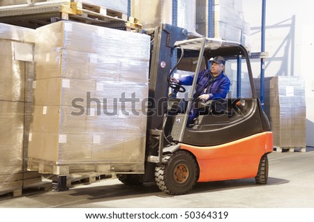Forklift loader worker driver at warehouse