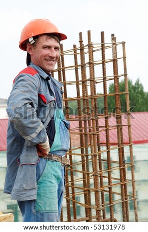 cheerful smiling builder worker at construction site