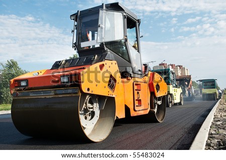 Group of compactors and Heavy Vibration rollers at asphalt pavement works (road repairing)