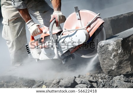 construction work of stone cutting by cut-off saw with diamond wheel