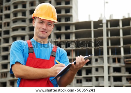 One happy builder worker with clipboard inspecting construction site