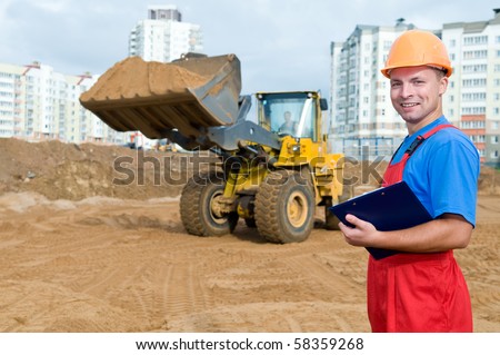 One builder worker with clipboard inspecting earthmoving works at construction site