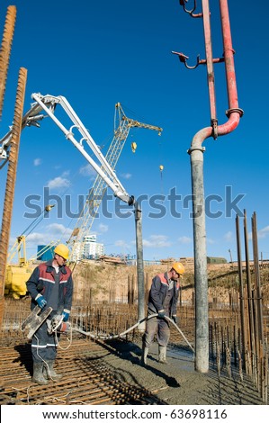 builder laborers works on construction site. Concrete pump and Vibration