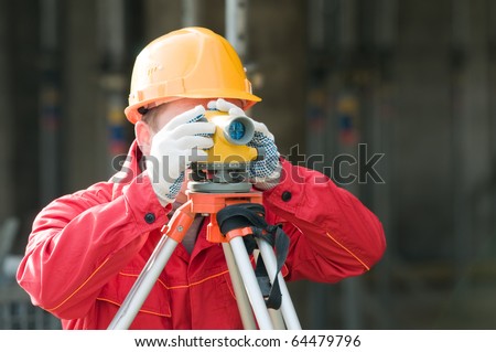 builder surveyor working with optical equipment level at construction site