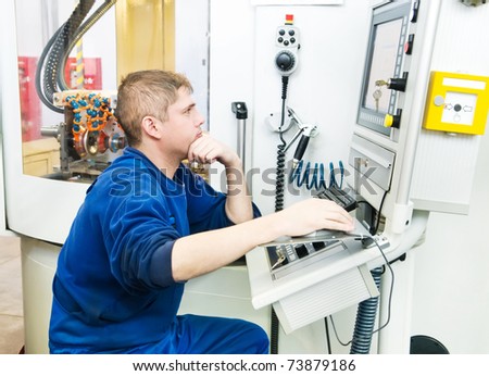 mechanical technician operative of cnc milling cutting machine center at tool workshop