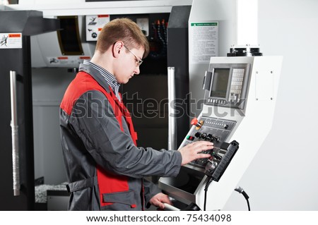 mechanical technician worker at cnc metal machining milling center in tool workshop