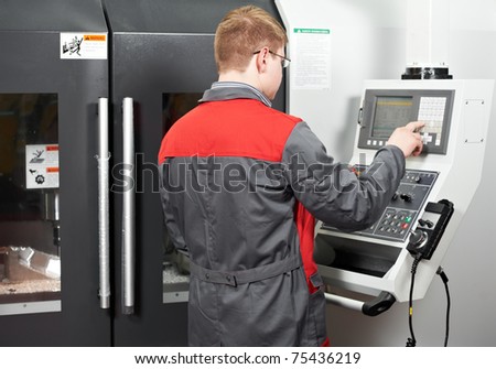 mechanical technician worker at cnc metal machining milling center in tool workshop