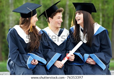 group of three graduation students in the park ? cheerful and happy