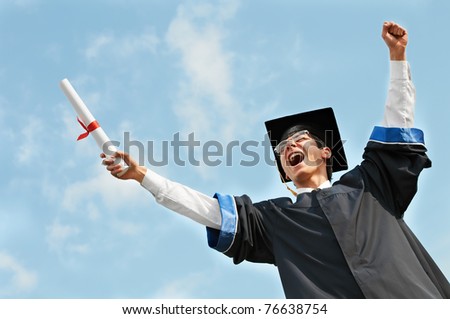 excited graduate student in gown with risen hands holding diploma over blue sky