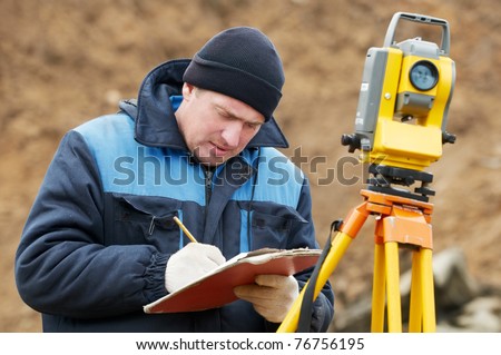 Surveyor worker make data collection with total station theodolite at construction site