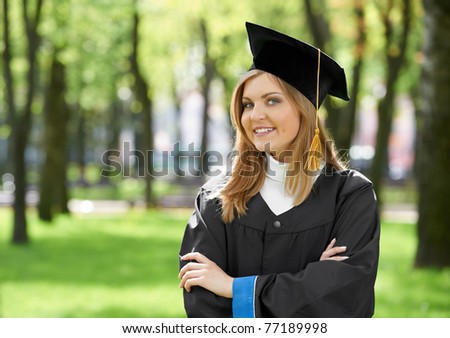 smiling female graduate student girl in the park cheerful and happy