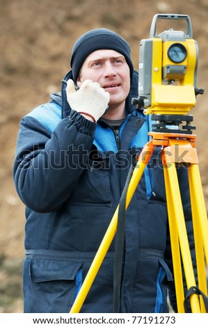 Surveyor worker make data collection with total station theodolite at construction site
