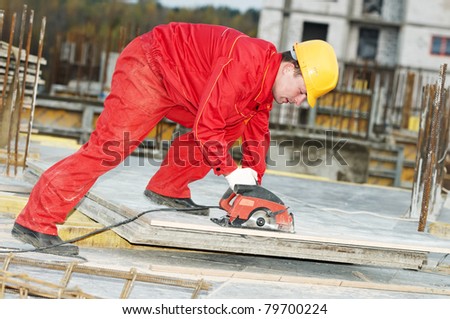 Builder with metal circular saw machine cuting construction wood board