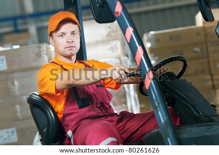 Warehouse worker distributing goods in a storehouse with forklift truck loader