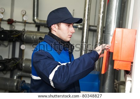 maintenance repairman engineer operating of heating system equipment in a boiler house