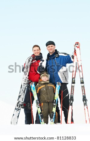 Happy Mother father and child with winter sport gear outdoors