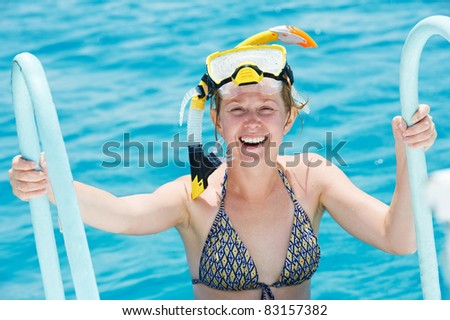 active smiling woman going out of red sea with snorkel equipment