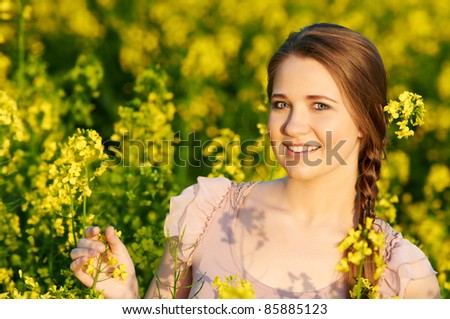 stock photo beautiful smiling young girl at yellow green rape meadow