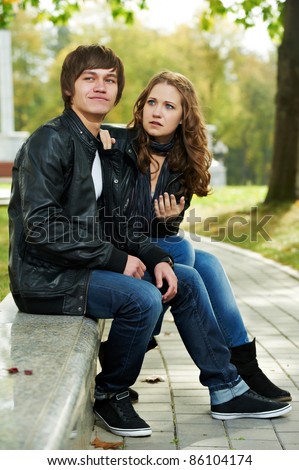 conflict and stress in young people couple relationship outdoors. Grining man and sad girl