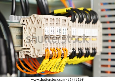 Automatic electrical fuseboxes and power lines located inside of an industrial switch control panel board