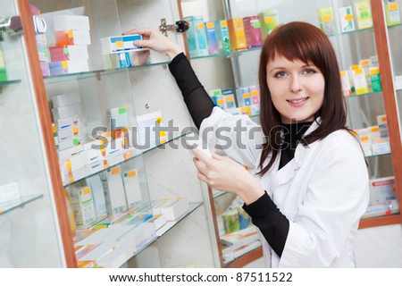 pharmacist chemist woman looking for medicine in pharmacy drugstore with recipe
