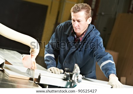 mechanical technician carpenter worker with circular saw machine at wood furniture manufacturing workshop