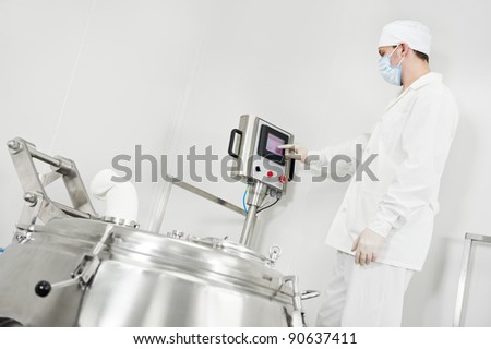 pharmaceutical factory worker at pharmacy industry manufacture with granulator