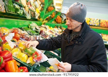 man choosing produces in vegetable shopping mall supermarket