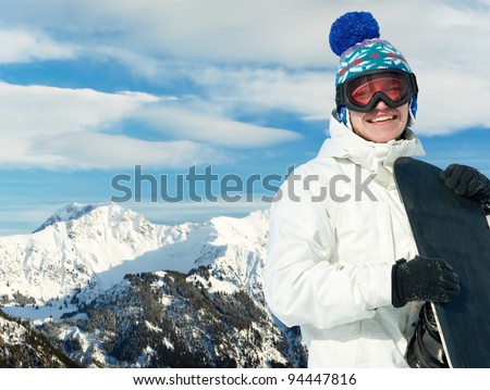 smiley happy sportsman with snowboard at winter mountain outdoor
