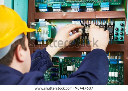 Electrician at safety fuse device replace work at electric power switch line box